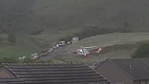 Helicopter and emergency vehicles at Arthur's Seat