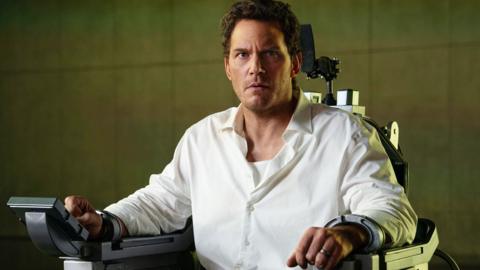 Chris Pratt locked in an executioner's chair, he's in a white shirt and looks very concerned
