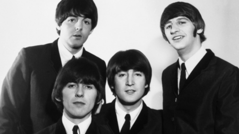 Sounds of Liverpool at the BBC. The Beatles backstage at Top of the Pops. The black and white images features (left to right) Paul McCartney, George Harrison, John Lennon and Ringo Starr in black suits and ties with white shirts and their signature bowl hair cuts.