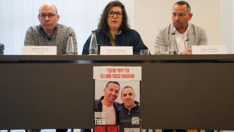 Stephen Brisley, Sharone Lifschitz, Sharon Sharabi who are family members of four people taken hostage by Hamas in Israel on October 7, speak during a press conference at the office of Mishcon de Reya in London