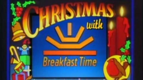 Blue screen with Christmas symbols including holly, a robin and presents. 'Christmas with Breakfast Time' is written on the screen