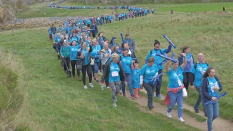 Thousands of walkers snake their way along the route