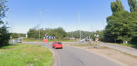 Cars on a roundabout.
