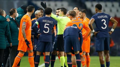 Istanbul Basaksehir and PSG players talk with the referee