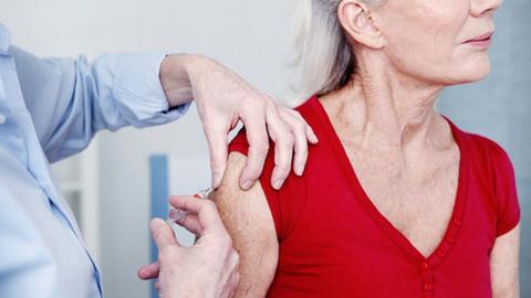 An elderly woman being vaccinated