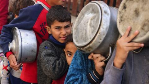 Children queuing to receive food in Rafah