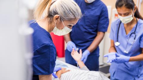 Doctors and nurses with patient in hospital