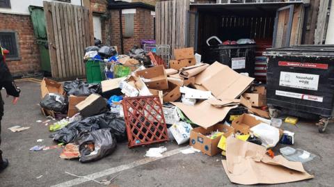 Rubbish left behind The Curve, including rubbish bags, a plastic bread tray and lots of cardboard