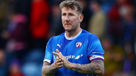 Kyle McFadzean applauds the Chesterfield fans after their play-off semi-final first leg defeat by Notts County