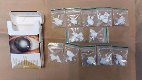 Cigarette box and bags of cocaine