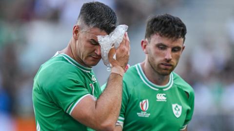 Jonathan Sexton cools himself with an ice pack during a water break at the 2023 World Cup in France