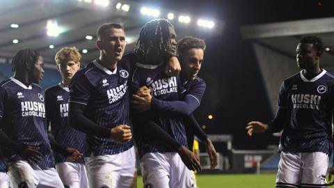 Millwall players celebrate their side's goal at the Den