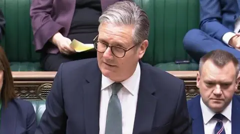 Starmer, wearing a suit and tie, making a statement to the Commons