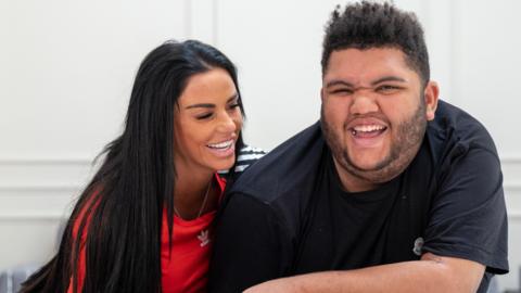 Katie Price and son Harvey smiling at the camera