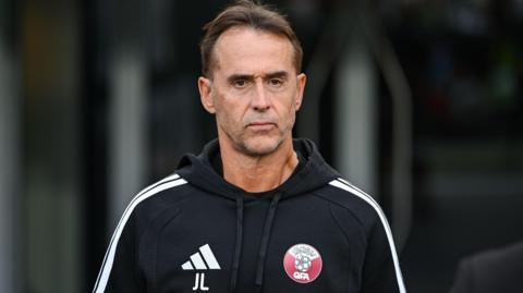 Julen Lopetegui looking stern wearing a Qatar FA branded hooded top