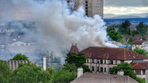 Huge clouds of smoke billow from a block of flats
