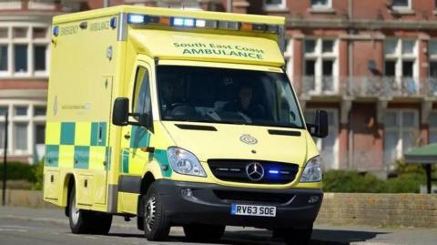 An ambulance parked on the side of a road