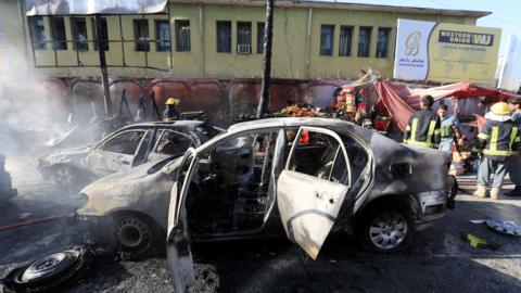 Afghan police inspect the site of a blast in Jalalabad, Afghanistan, July 1, 2018