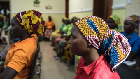 Released Chibok girl viewed in profile at ceremony meeting President Buhari of Nigeria