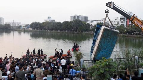 A crane pulls out the boat which capsized in Harni Lake carrying children and teachers who were on a picnic, in Vadodara, India, January 18, 2024.