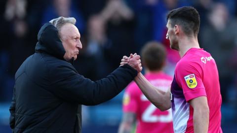 Huddersfield boss Neil Warnock congratulates Matty Pearson after their win at Millwall