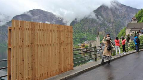 Wooden fence with backdrop of Austrian town of hallstatt