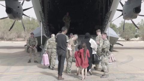 British family boards military plane in Sudan