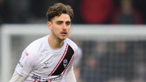 Tom Bayliss in action for Lincoln City