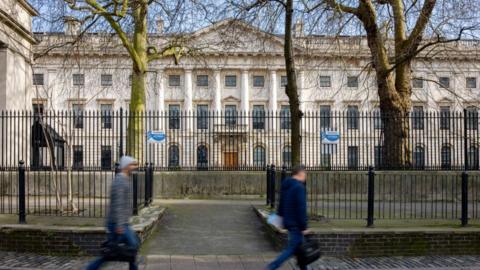 Passers-by walk past the the Royal Mint Court office complex in the City of London the possible future site of a new Chinese Embassy 