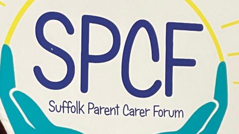 A logo for the Suffolk Parent Carer Forum. The name of the group is painted in blue letters while there are turquoise hands painted underneath to look like they are holding the letters.