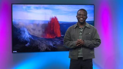 De-Graft in the studio with a volcano in the screen