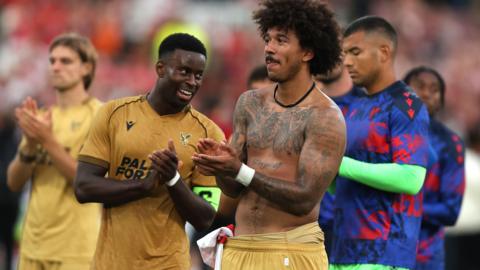 Marc Guehi and Chris Richards applaud the Crystal Palace fans