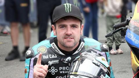 Michael Dunlop celebrates winning the Supersport TT on the Isle of Man