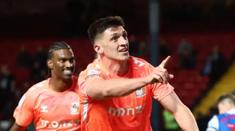 Bobby Thomas celebrates scoring Coventry's equaliser at Blackburn