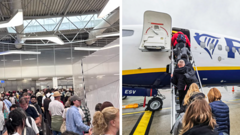 People queue at Athens airport in long lines in a white terminal building.