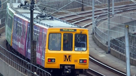 Old yellow South Hylton train travelling to a station