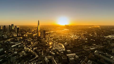 An aerial view of London with the sun setting 