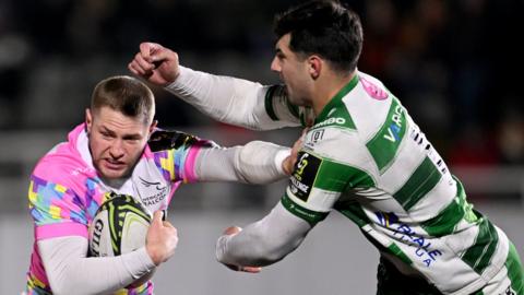 Newcastle Falcons' Tom Penny (left) holds off Benetton's Tommaso Menoncello