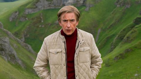 Steve Coogan as Alan Partridge standing in a wild landscape