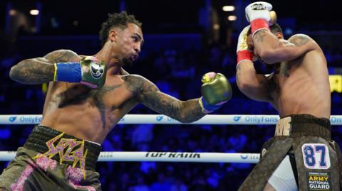 Great Britain's Ben Whittaker punches Richard Rivera during their light-heavyweight bout in Brooklyn