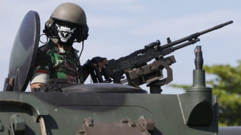 An Indonesian military officer operates an armored vehicle during Christmas and New Year security preparations in Denpasar, Bali, Indonesia, 22 December 2016.