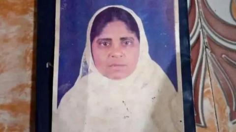 A passport photo of Hamida Banu, wearing a white scarf.