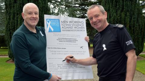 Deputy Chief Constable Iain Livingstone signs the white Ribbon pledge