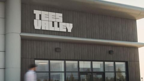 The headquarters of the Tees Valley Combined Authority, which is based at Teesside Airport. The entrance has wooden panels and a glass-fronted entrance.