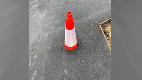 Orange and white plastic traffic cone