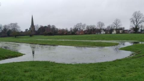 Meadows with a church in the background