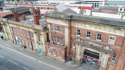 A historic red brick building with a sign reading 'Hope Foundry'