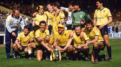 Oxford United v Queens Park Rangers at the Milk Cup Final on 20 April 1986, Oxford players and coach Ray Graydon celebrate with the trophy.