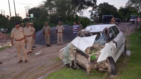 Police next to the crashed car in Uttar Pradesh (28 July 2019)