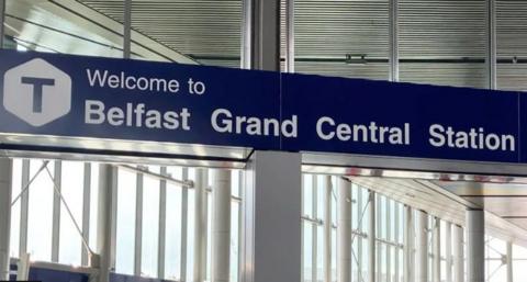 A blue sign which reads 'Welcome to Belfast Grand Central Station'